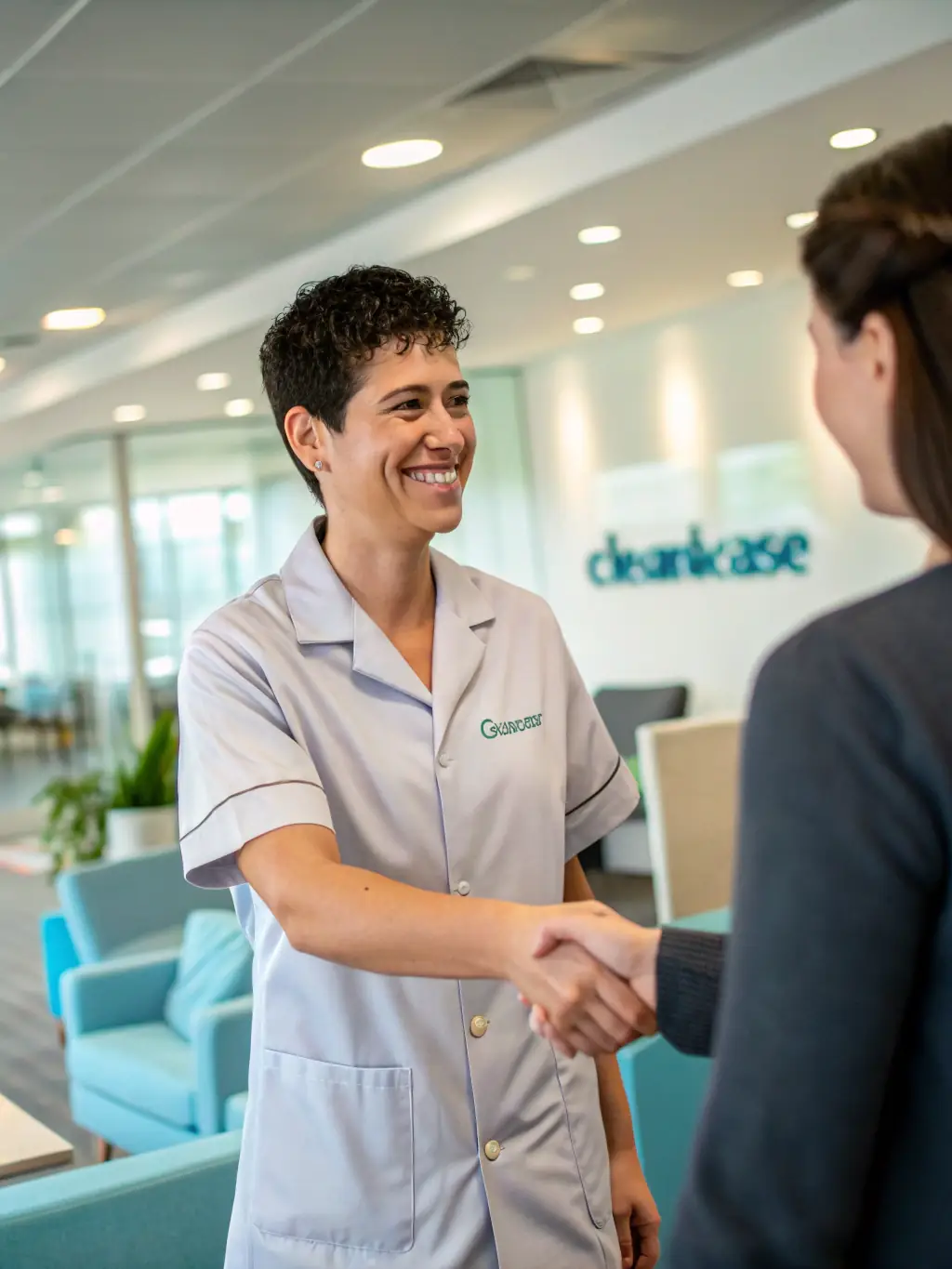 A smiling home service business owner shaking hands with a Masaru Media representative, symbolizing a successful partnership.